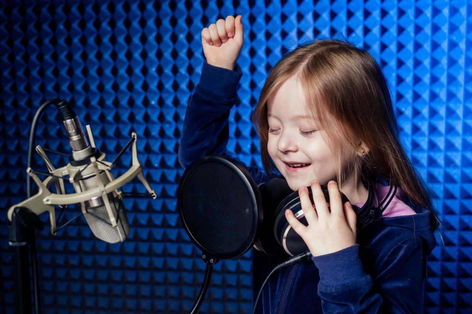 Voice artist recording in studio with headphones